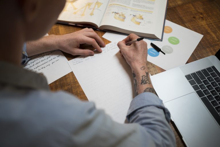 close-up-young-man-writing-virtual-classroom